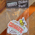 A sticker pack from Chromatic Coffee Co. displayed on a wooden surface, including various stickers with coffee-related illustrations and text.