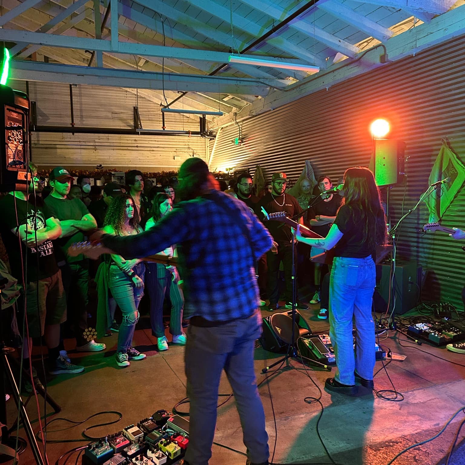 A band performs in the cafe space to a large crowd