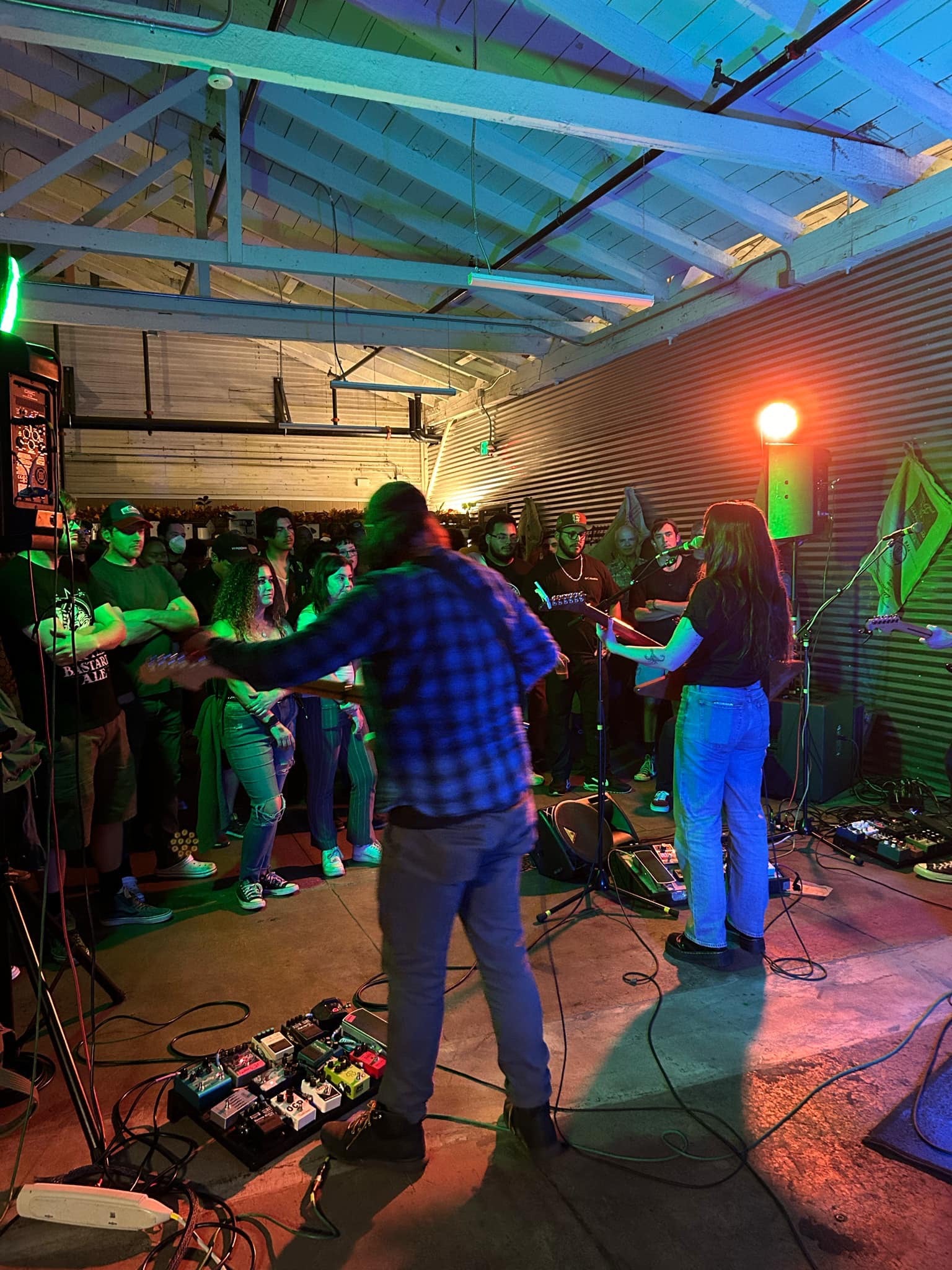 A band performs in the cafe space to a large crowd